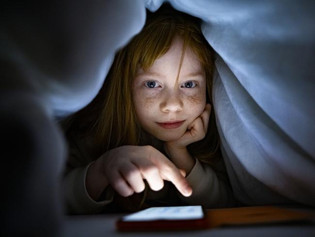 Girl using internet on mobile phone in the night