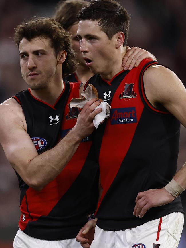 Dejected Essendon players walk from the ground. Picture: Darrian Traynor/Getty Images