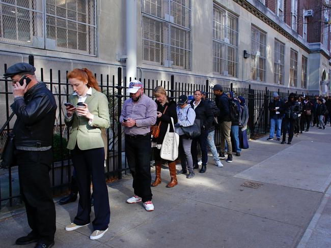 People wait in line outside a school to vote in the presidential election November 8, 2016 in the Harlem Borough in New York City. Picture: AFP PHOTO / KENA BETANCUR