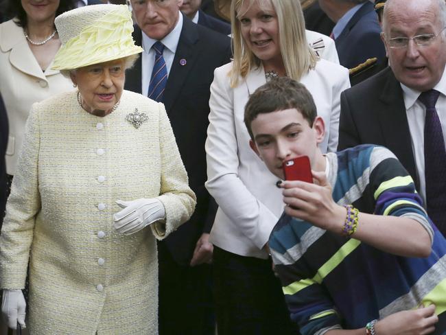 A youth blags a selfie with The Queen in Belfast. Picture: AP Photo/Peter Macdiarmid