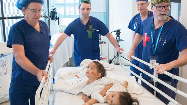 Surgeons at the Royal Children’s Hosptial with twins Nima and Dawa before their separation surgery.