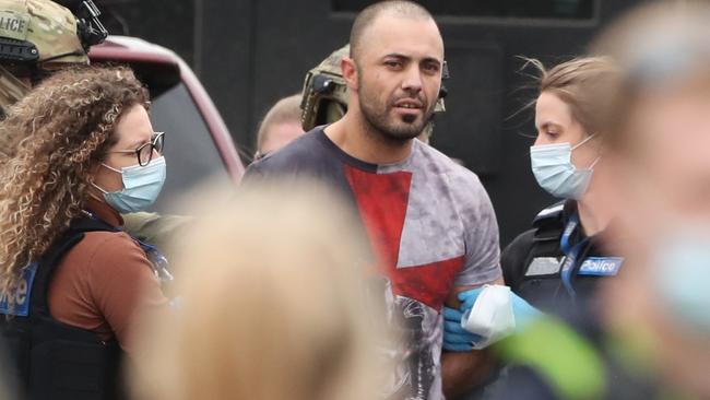 Ricky Brockdorff being led from a Point Cook house by police on Tuesday afternoon. Picture: David Crosling