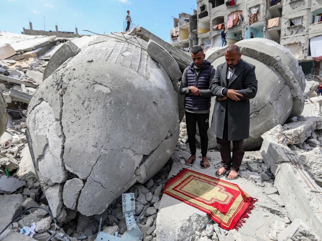 Palestinians pray during Ramadan on the remains of Al-Farouq Mosque, which was destroyed in Israeli air strikes on Rafah. Picture: Ahmad Hasaballah/Getty Images