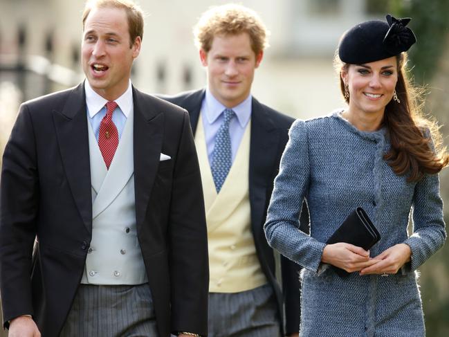 Happier times. The Duke and Duchess of Cambridge flank Prince Harry at a wedding in March 2014. Picture: Max Mumby/Indigo/Getty Images