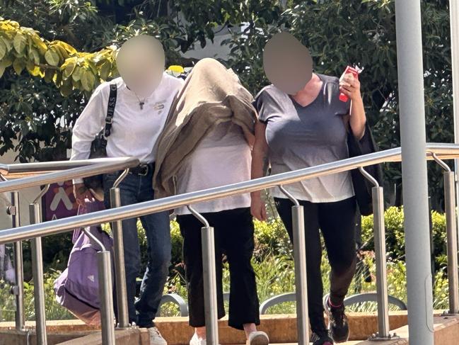 Cheryl Anne Johnston, 62, in the middle, leaves Rockhampton Supreme Court.