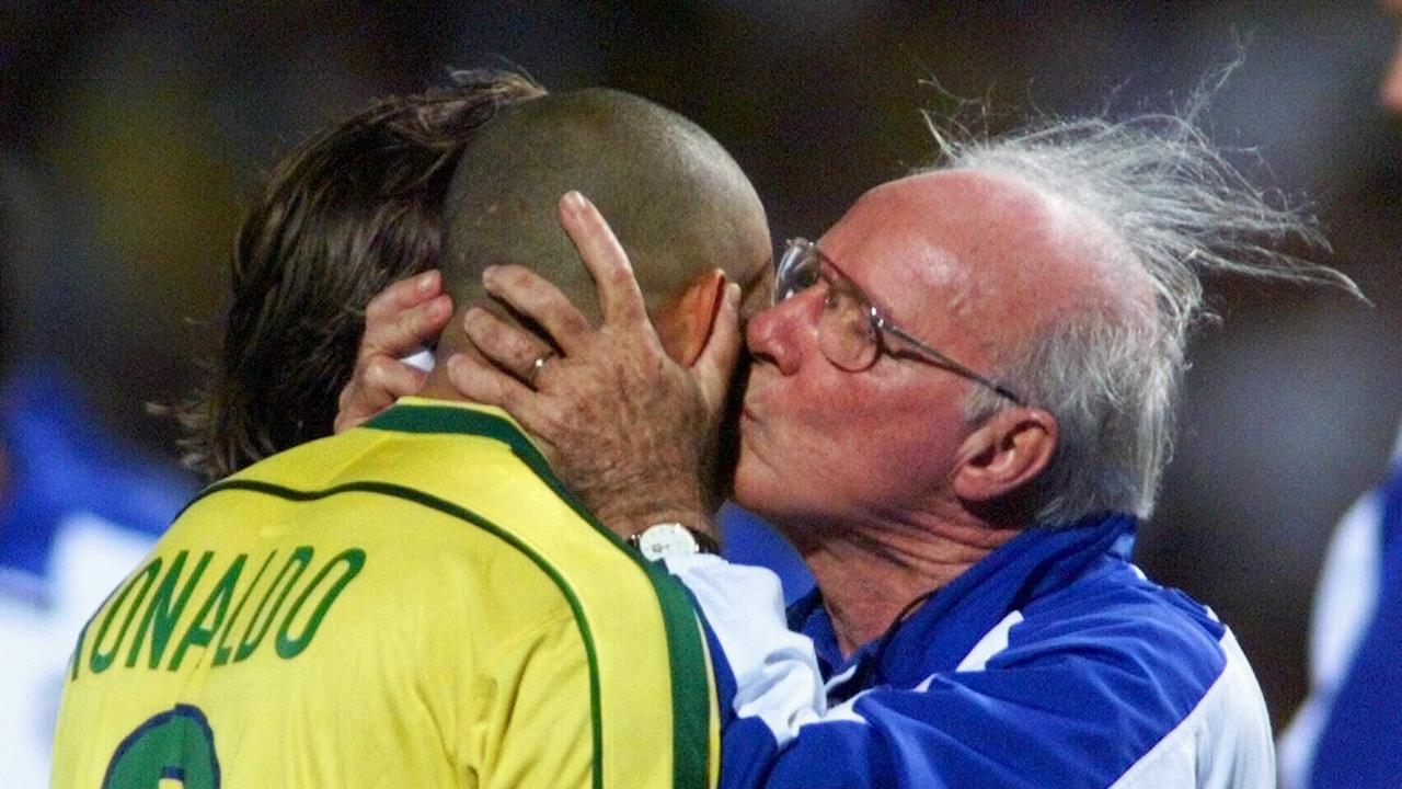 Brazil's head coach Mario Zagallo kisses Ronaldo's head after the 1998 World Cup semi-final shootout win.