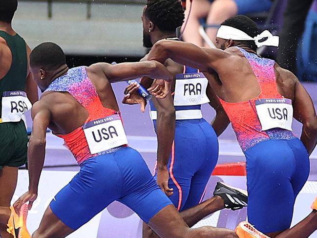 PARIS, FRANCE - AUGUST 09:  Christian Coleman of Team United States (3R) attempts to pass the baton to team mate Kenneth Bednarek (R) in the Men's 4x100m Relay Final on day fourteen of the Olympic Games Paris 2024 at Stade de France on August 09, 2024 in Paris, France. (Photo by Patrick Smith/Getty Images)