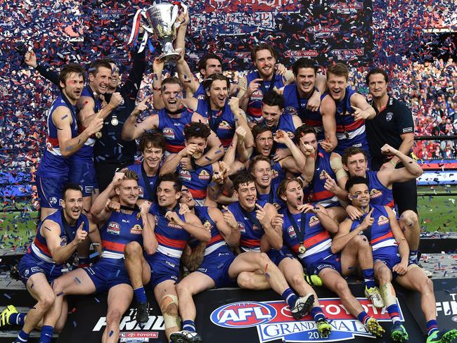 Bulldogs players react after winning the AFL Grand Final between the Sydney Swans and the Western Bulldogs at the MCG in Melbourne, Saturday, Oct. 1, 2016. (AAP Image/Julian Smith) NO ARCHIVING, EDITORIAL USE ONLY