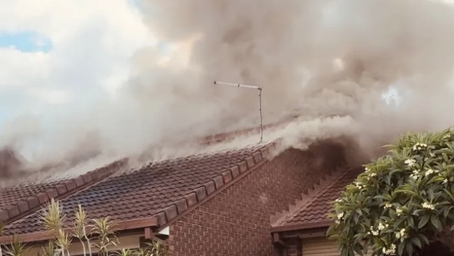 Fire billowing from a unit at Barbaralla Drive in Springwood on December 19, 2023.