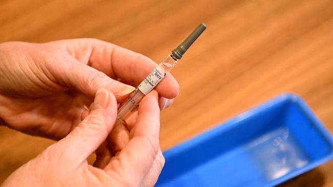 BRISBANE, AUSTRALIA - NewsWire Photos - APRIL 13, 2023.A nurse holds a syringe containing the flu vaccination. The Government is encouraging Queenslanders to get their flu jab ahead of winter.Picture: Dan Peled / NCA NewsWire