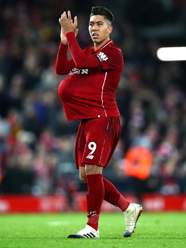 Roberto Firmino of Liverpool leaves the pitch with the match ball under his shirt following his hat-trick against Arsenal at Anfield. Picture: Getty Images