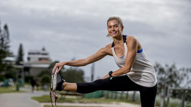 Gold Coast Marathon ambassador and long distance runner Dani Byrnes stretches as part of her training routine for this year’s event. Picture: Jerad Williams