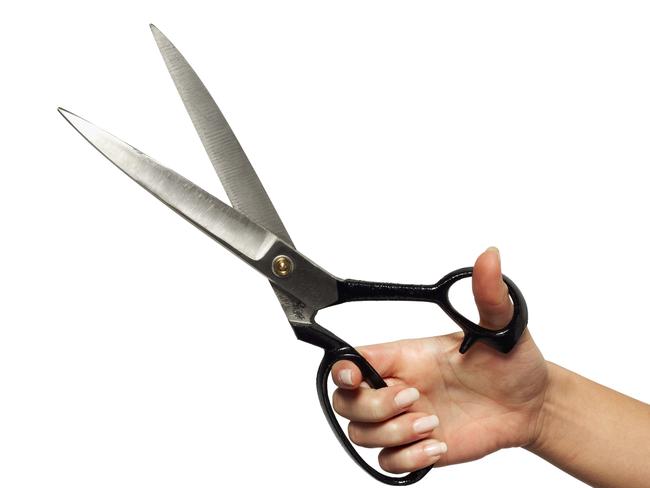 Close-up of woman's hand holding scissors. Cutting. Cuts. Generic image.