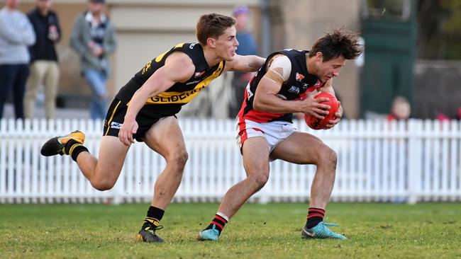 West Adelaide gun Kaine Stevens tries to shake Glenelg’s Carl Nicholson. Picture: AAP/ Keryn Stevens