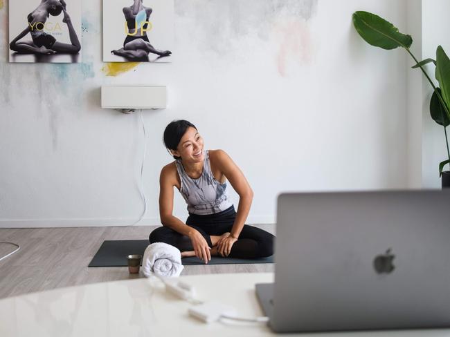 Hong Kong based YogaUP founder Chaukei Ngai smiles after concluding a live streamed yoga class via Zoom. Experts say online fitness platforms are here to stay. Picture: Anthony Wallace/AFP