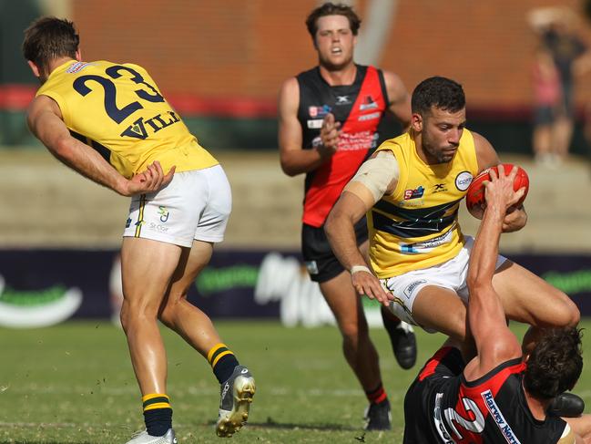 SANFL match between West Adelaide and Eagles at City Mazda Stadium. Eagles Jimmy Toumpas tangles with Wests Aaron Anderson. 19 April 2019. Picture Dean Martin