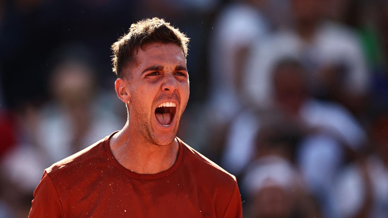 TOPSHOT - Australia's Thanasi Kokkinakis celebrates his victory over Switzerland's Stan Wawrinka during their men's singles match on day four of the Roland-Garros Open tennis tournament at the Court Simonne-Mathieu in Paris on May 31, 2023. (Photo by Anne-Christine POUJOULAT / AFP)