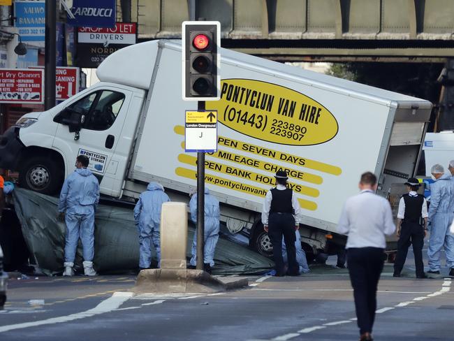 Forensic officers move the van at Finsbury Park in north London, where a vehicle struck pedestrians. Picture: Frank Augstein/AP