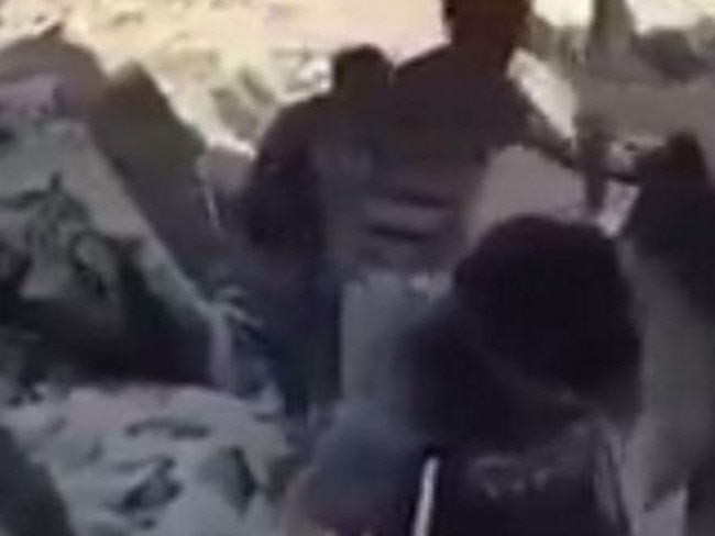 Video footage shows several suspected ISIS fighters emerging from hiding.