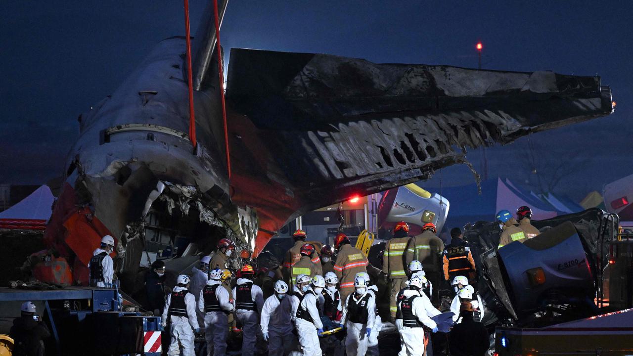 Firefighters and rescue personnel work at the scene. Picture: Jung Yeon-je/AFP