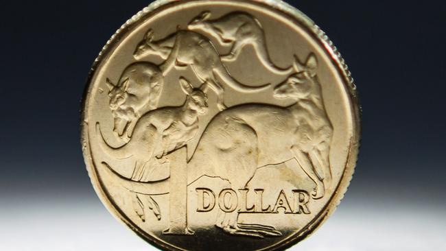 An Australian one-dollar coin is arranged for a photograph in Sydney, Australia, on Wednesday, April 17, 2013. Direct trading between the Australian dollar and yuan started on April 10. Photographer: Ian Waldie/Bloomberg