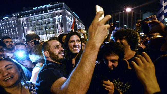 Greek parliament’s president and Syriza party member Zoe Kostantopoulou, centre, takes a selfie with a ‘No’ supporter as she joins the celebrations in front of the parliament.