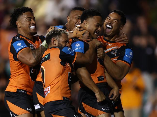 SYDNEY, AUSTRALIA - AUGUST 22: Latu Fainu of the Wests Tigers celebrates scoring a try during the round 25 NRL match between Wests Tigers and Manly Sea Eagles at Leichhardt Oval on August 22, 2024 in Sydney, Australia. (Photo by Jason McCawley/Getty Images)