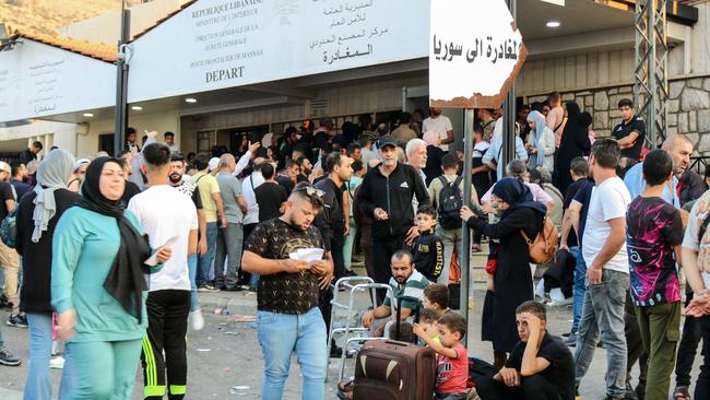 People fleeing Israeli bombings in Lebanon prepare to cross the border with Syria through the Masnaa crossing is eastern Lebanon. Picture: AFP.