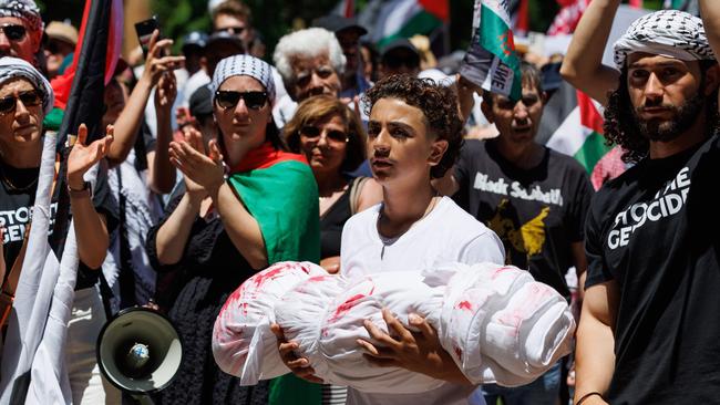 A Pro-Palestinian protest in which a member holds a symbol of a dead child. Picture: David Swift