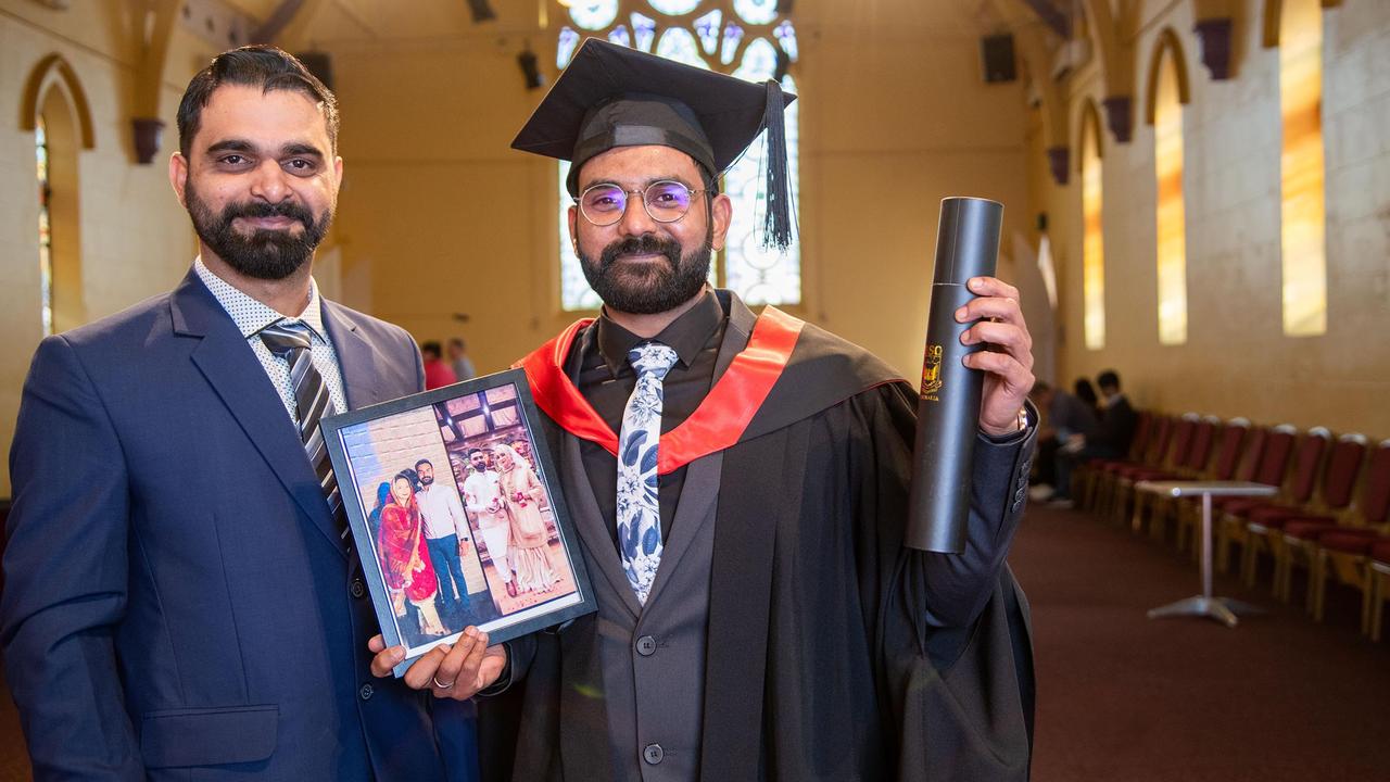 Holding a photograph of his wife, Bashir, who was unable to attend the graduation, Muhammad Farooq Bashir, graduated with a Master of Information Systems. Helping celebrate the occasion is friend, Shoaib Khalid. UniSQ graduation ceremony at Empire Theatre. Wednesday, June 28, 2023