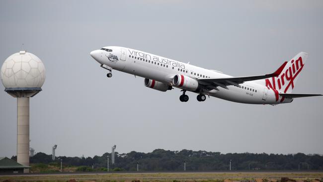 Sydney Airport says Virgin Australia is holding on to all its slots despite its intended reduction in flights. Picture: NCA NewsWire / Christian Gilles