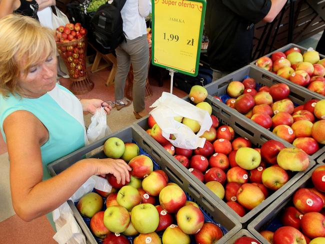 A woman is picking apples to buy at 1.99 zlotys (euro 0.47) per kilogram at a supermarket in Warsaw, Poland, Wednesday, Aug. 6, 2014, the day when fruit farmers marched in the city intending to encourage Poles to eat more apples and this way offset the expected negative effects of a ban that Russia imposed last week on Polish fruit, a move seen as retaliation for European Union sanctions on Moscow over Ukraine. Poland is among Russia’s largest suppliers of apples. (AP Photo/Czarek Sokolowski)