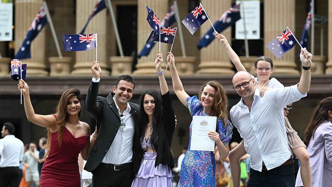 Italian migrants Andrea Abate and Chiara Trotta, second and third from left, celebrate with fellow new citizens in Brisbane on Friday. Picture: Lyndon Mechielsen