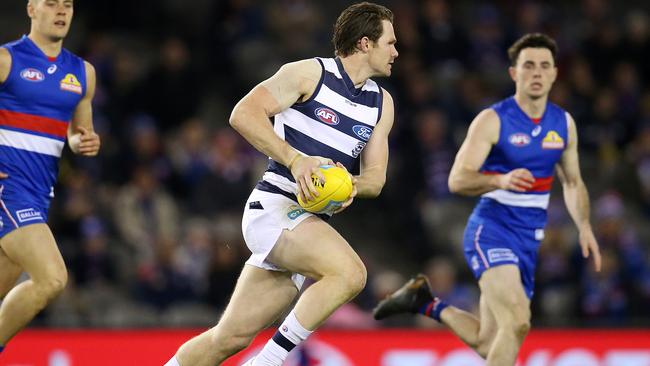 The boundary fence drew blood, but it didn’t slow Patrick Dangerfield down. Picture: Michael Klein