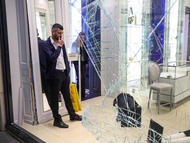 Store employees survey the carnage. Picture: Brendan Beckett