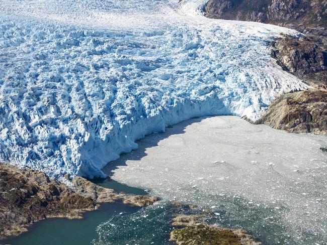 EMBARGO FOR TWAM, 05 OCTOBER 2024. FEE MAY APPLY. Aerial view of El Brujo Glacier On The Edge Of The Sarmiento Channel in Bernardo O'Higgins National Park in Patagonia Chile fjords near Puerto Natales, Chile. Climate change and mining threaten Chile's glaciers. With a long and narrow territory, Chile has 4% of the world's glaciers and 80% of those in South America, located in the Andes Mountains. It is one of the most important water reserves in the world, but everything could change quickly due to the effects of global warming and activities such as mining. All but three of the ice masses present in Chile are receding and many of them have broken up, accelerating melting even more. In addition to climate change, industrial activities such as mining are added to the list of threats. Mining activities generate different types of pollutants that directly affect glaciers. Many sterile materials are deposited on rock glaciers, generating an overload and destabilizing the structure of the ice. (Photo by: Sergi Reboredo/VW Pics/Universal Images Group via Getty Images)