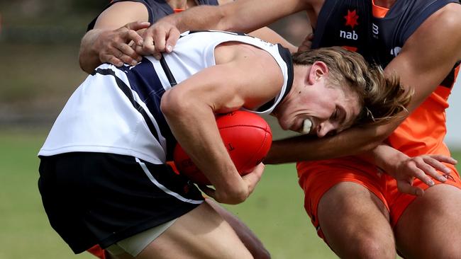 Joel Trudgeon tries to duck out of a tackle.