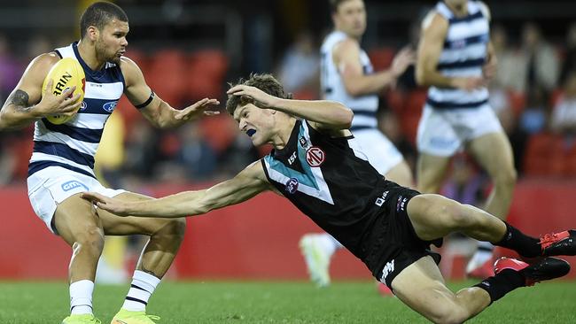 Parfitt avoids a tackle by Port Adelaide’s Mitch Georgiades. Picture: Matt Roberts/Getty Images