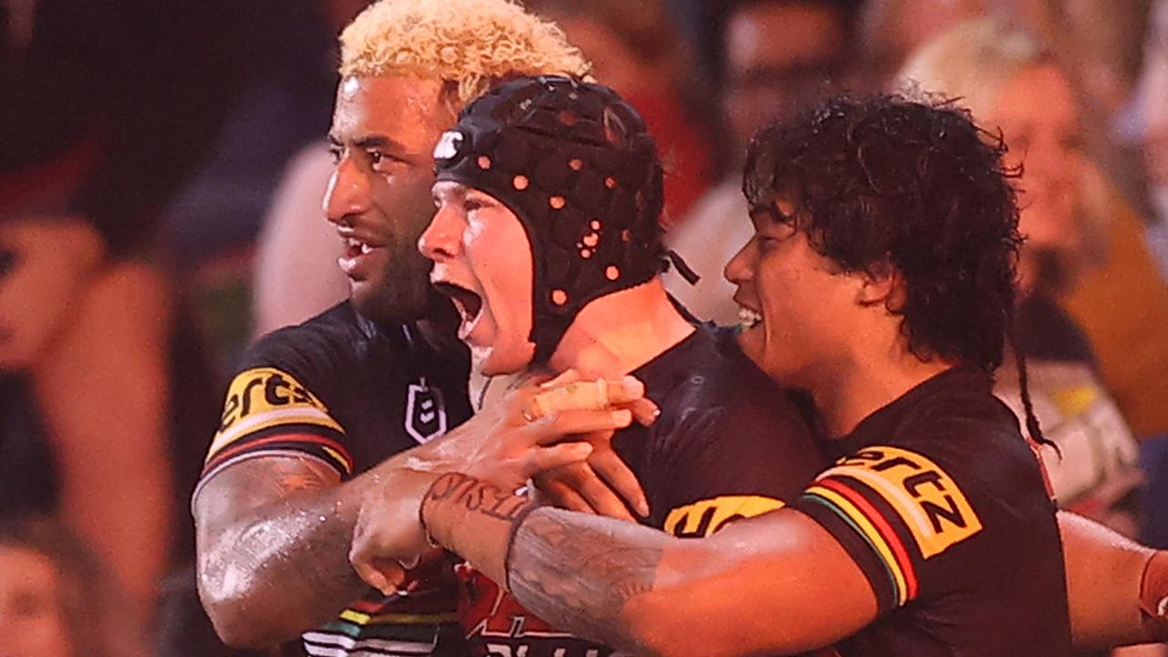 Matt Burton of the Panthers celebrates with teammates after scoring a try.