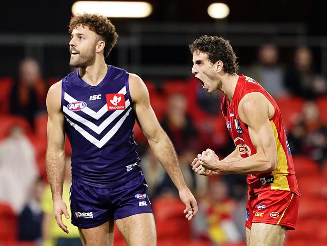 Ben King of the Suns (right) reacts after kicking a goal as Griffin Logue of the Dockers looks on during the Round 4 AFL match between the Gold Coast Suns and the Fremantle Dockers at Metricon Stadium on the Gold Coast, Saturday, June 27, 2020. (AAP Image/Dave Hunt)