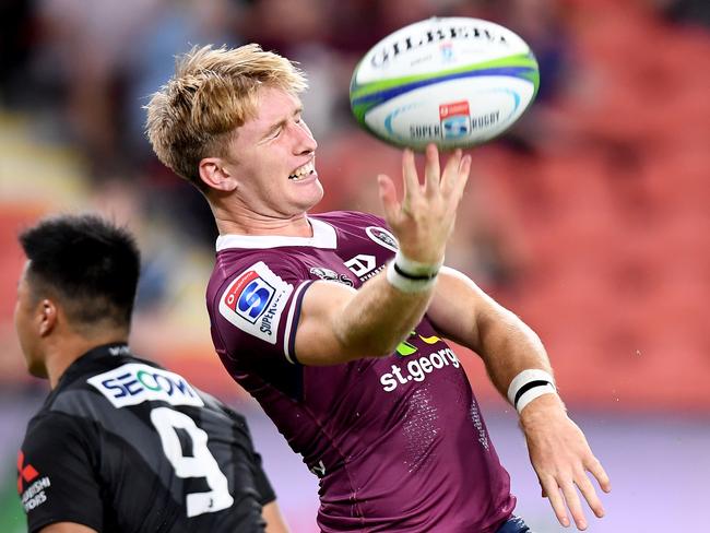 Reds halfback Tate McDermott celebrates scoring a try. Picture: Getty Images