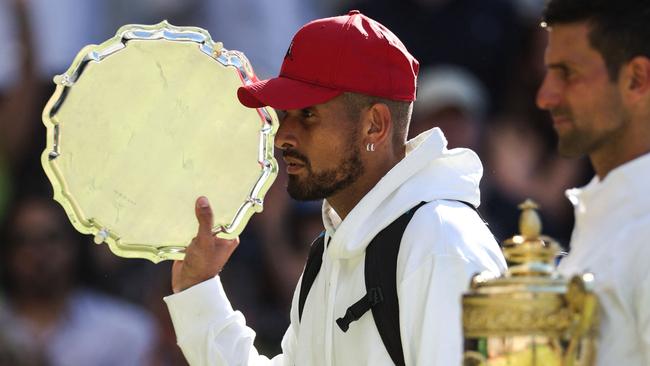 Australia's Nick Kyrgios (left) holds the runner-up's trophy next to Serbia's Novak Djokovic after their men's singles final tennis match of the 2022 Wimbledon Championships. Picture: Adrian Dennis/AFP