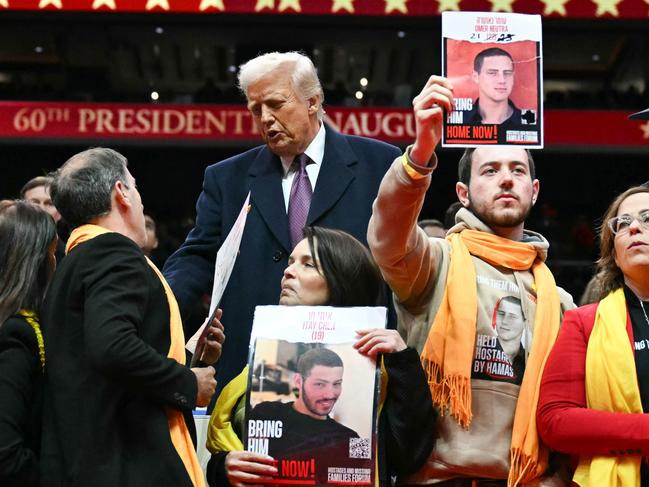 US President Donald Trump greets Relatives of Israeli hostages of Hamas during the inaugural parade inside Capital One Arena, in Washington, DC, on January 20, 2025. (Photo by Jim WATSON / AFP)