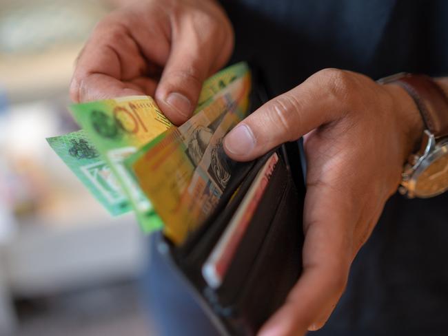 a male taking money out of the valet.