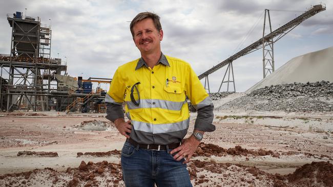 Patriot Battery Metals managing director Ken Brinsden standing in front of a concentrator and Spodumene ore stockpile. Picture: Colin Murty