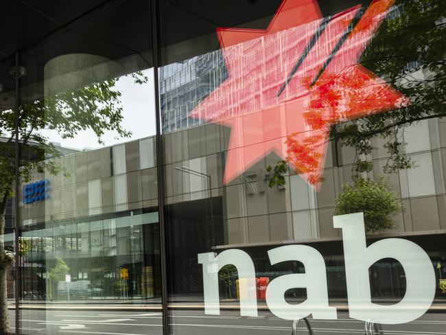 MELBOURNE, AUSTRALIA - NewsWire Photos JANUARY 12, 2020 : A cleaner is seen cleaning signage at a NAB in Docklands, Melbourne. Picture : NCA NewsWire / Daniel Pockett