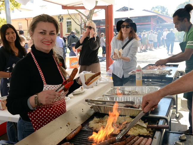 Vanessa Baumer-Rowley cooks the sausage sizzle at Neutral Bay Public School during the North Sydney Council Election. Pic: AAP Image/ Jeremy Piper