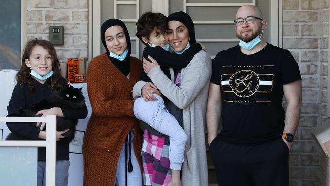 The Eaton family at their Yagoona home in western Sydney: Umar, left, Zaynab, Yunus, Fatima Merhi and Marcus Eaton. Picture: Jane Dempster