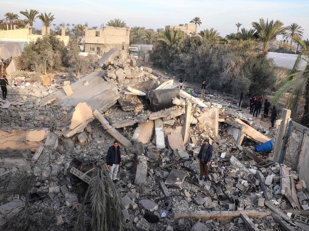 People check the destruction in the aftermath of an Israeli strike at Deir el-Balah in the central Gaza Strip on January 15. Picture: Eyad Baba/AFP