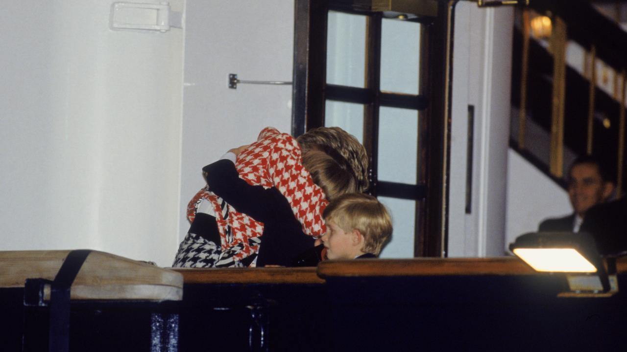 The Princess of Wales hugging Prince William as Prince Harry looks on, on the deck of the yacht Britannia in Toronto on October 23 1991. Picture: Jayne Fincher/Princess Diana Archive/Getty Images.